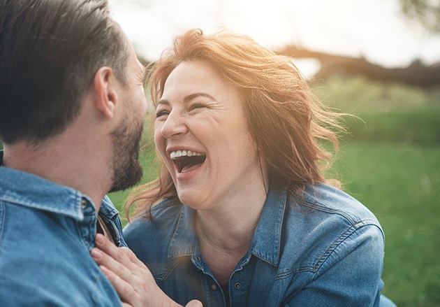 couple laughing together outside 