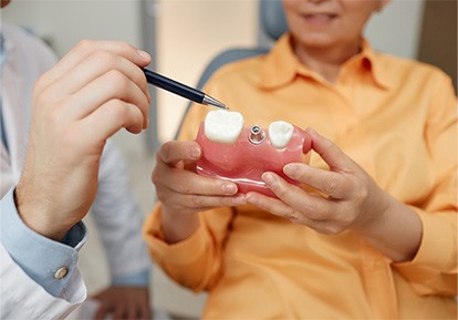 Plainview implant dentist talking to a dental patient